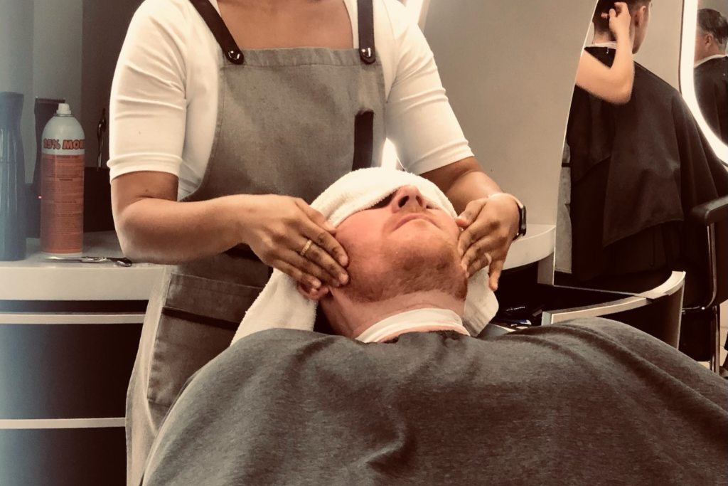 Man getting facial massage after a haircut